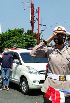 Para pengendara berhenti untuk menyanyikan Lagu Indonesia Raya.